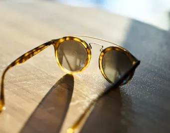 Woman wearing stylish sunglasses outdoors