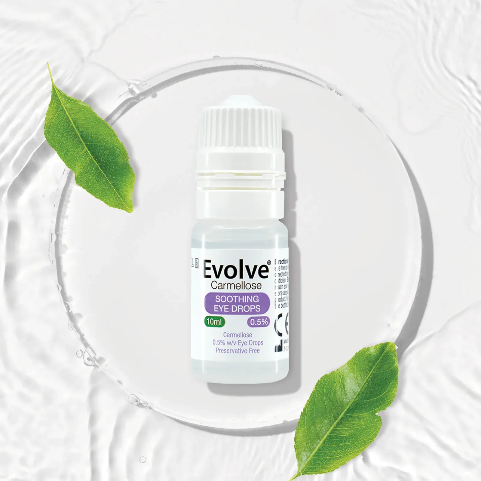 Evolve Carmellose bottle resting on a glass plate with green leaves