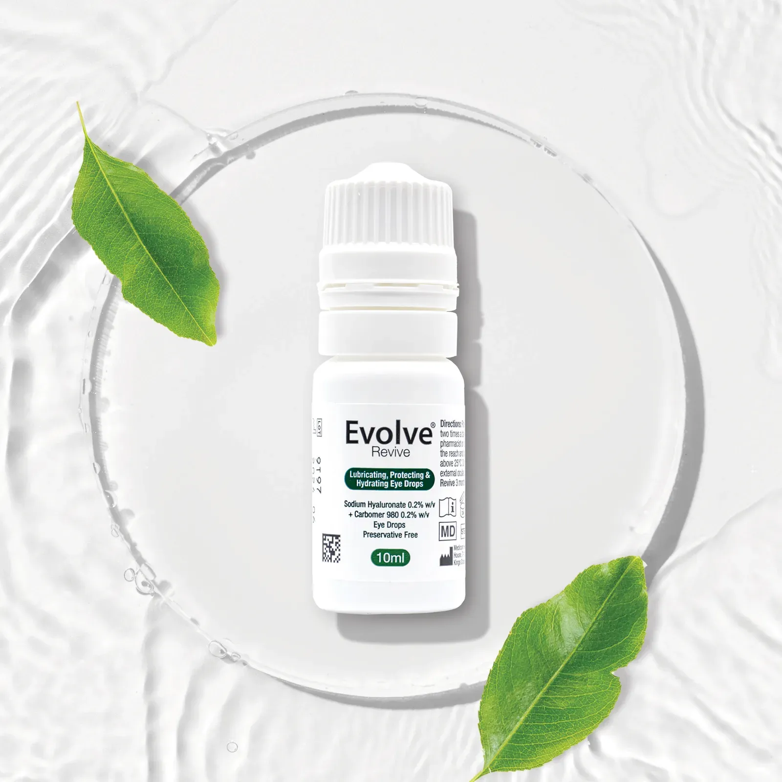 Evolve Revive bottle resting on a glass plate with green leaves