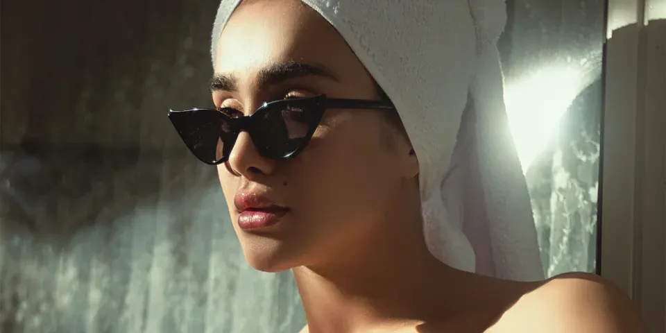 Woman wearing stylish sunglasses outdoors
