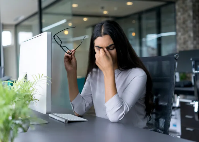 Person at a computer with tired, overworked eyes
