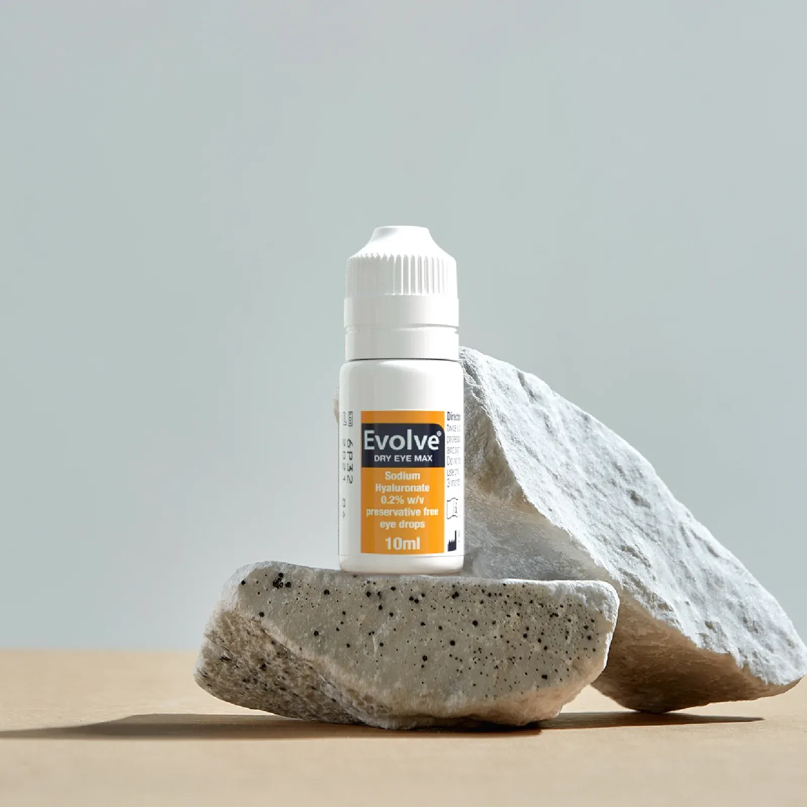 Evolve Dry Eye Max bottle on a stone podium